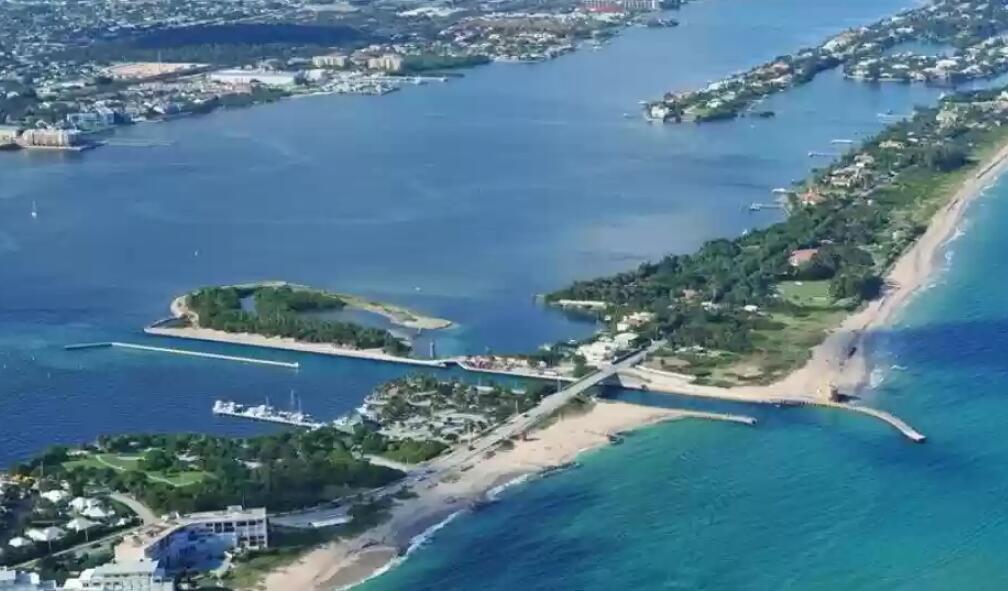 Aerial view of an inlet, a bridge, and coastal properties along a sandy beach — 4020 S Ocean Boulevard, Manalapan FL 33462, MANALAPAN, FL