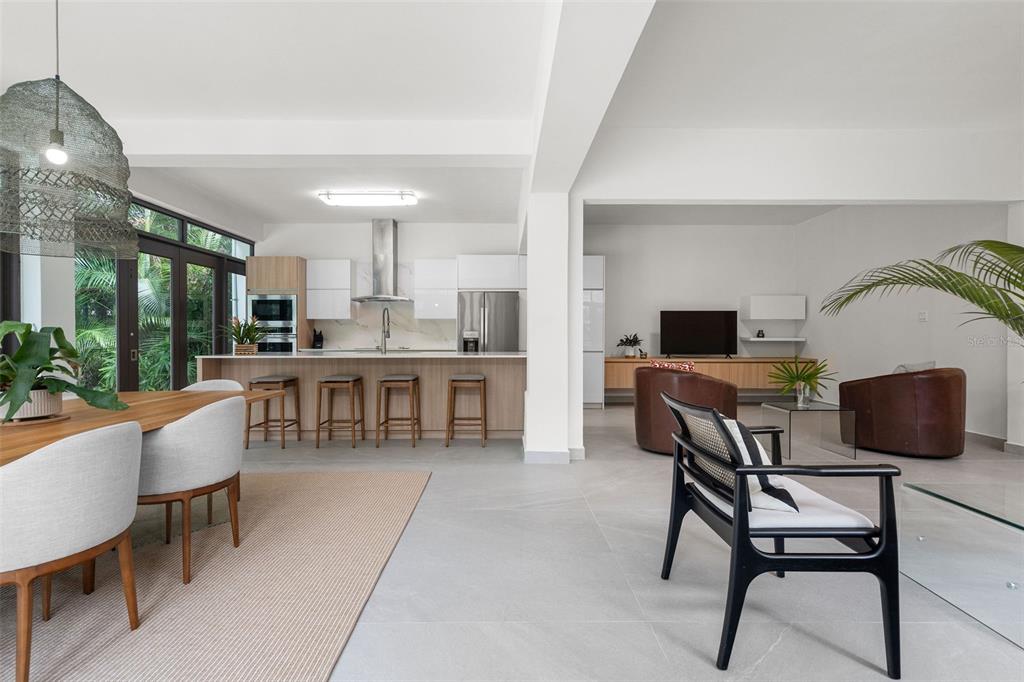 An open-concept living area features a modern kitchen with a breakfast bar and dining space — The Legends DORADO BEACH EAST UNIT 25, DORADO, PR