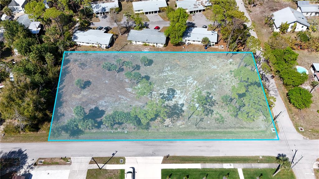 An aerial view shows a rectangular, undeveloped lot highlighted with a blue border — 212 CEDAR STREET, ENGLEWOOD, FL