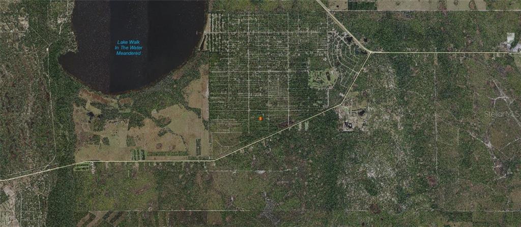 This is an aerial map showing a wooded area with a lake and grid-like street patterns — CALENDULA DRIVE, INDIAN LAKE ESTATES, FL