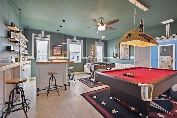 A game room features a pool table, a bar with stools, and a foosball table — 4542 NARRATIVE LANE, KISSIMMEE, FL