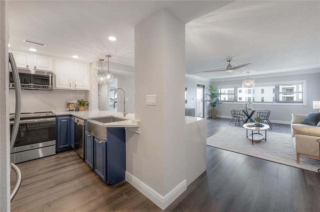 A kitchen with blue lower cabinets and white upper cabinets opens to a living area — 4141 BAYSHORE BOULEVARD UNIT 1003, TAMPA, FL