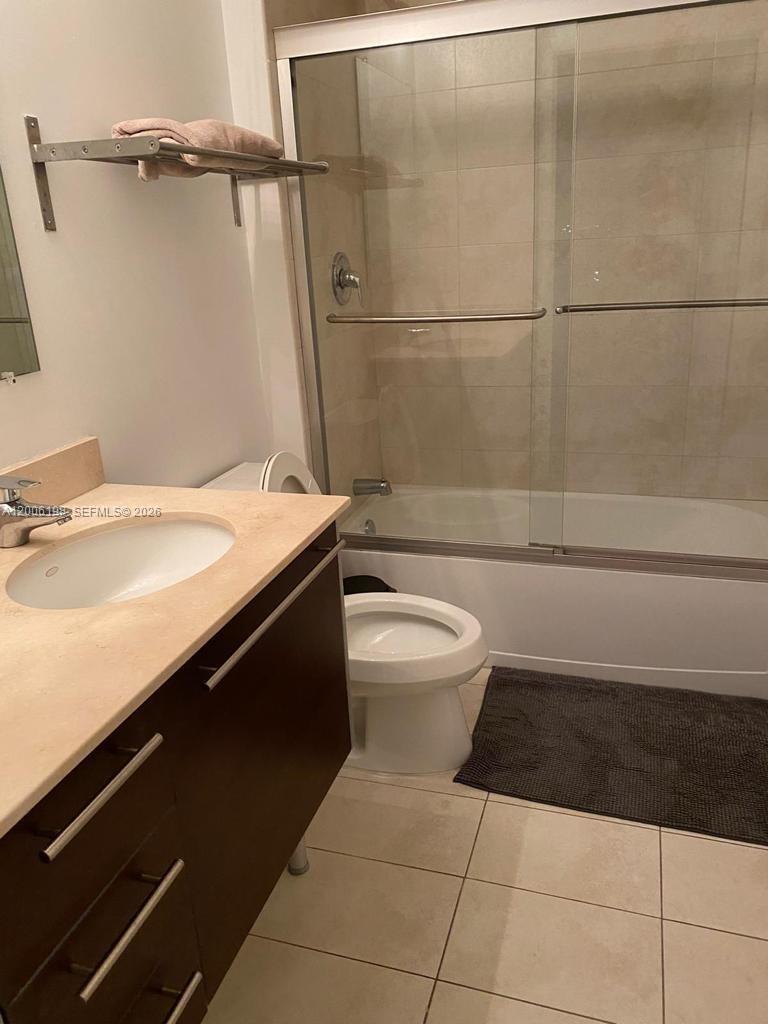 A bathroom features a vanity with a light countertop, a toilet, and a shower-tub combination — 1900 N Bayshore Dr # 2314, Miami FL 33132, MIAMI, FL