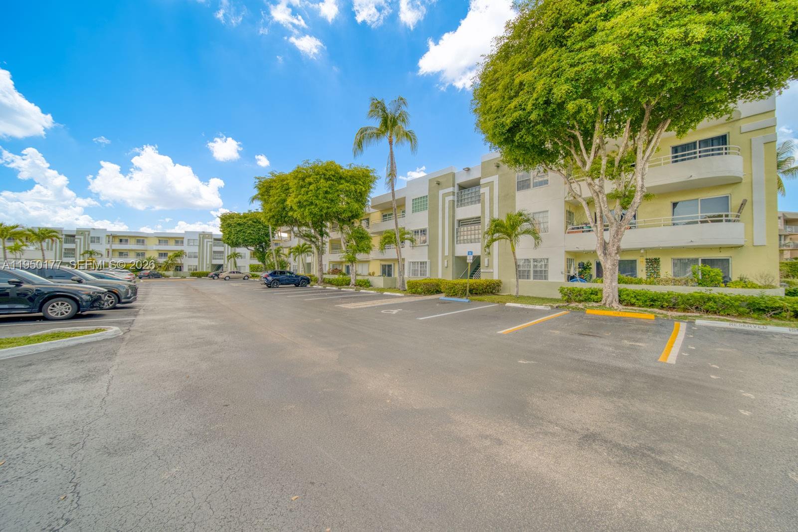 An exterior view shows a multi-story apartment building with a parking lot in front — 10795 SW 108th Ave # 304, Miami FL 33176, MIAMI, FL