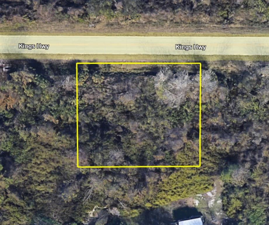 An aerial view shows a rectangular plot of land outlined in yellow along Kings Hwy — 4265 KINGS HWY, COCOA, FL