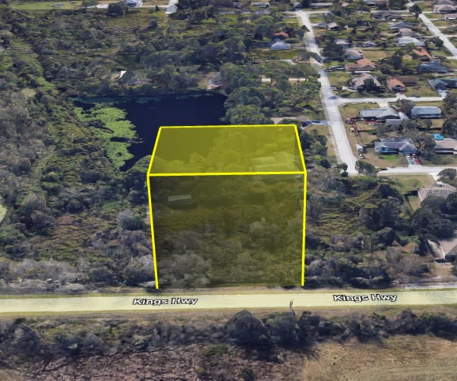 An aerial view shows a rectangular plot of land highlighted in yellow along Kings Highway — 4265 KINGS HWY, COCOA, FL