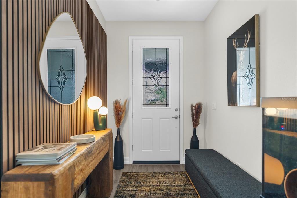 An entryway features a wood-slat wall, a rustic console table, a mirror, and a bench — 5100 WESTLAKE BOULEVARD, DADE CITY, FL