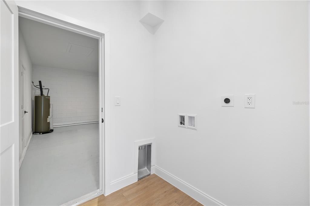 A laundry room with utility hookups and a doorway leading into a garage — 2421 W LANDMARK DRIVE, CITRUS SPRINGS, FL