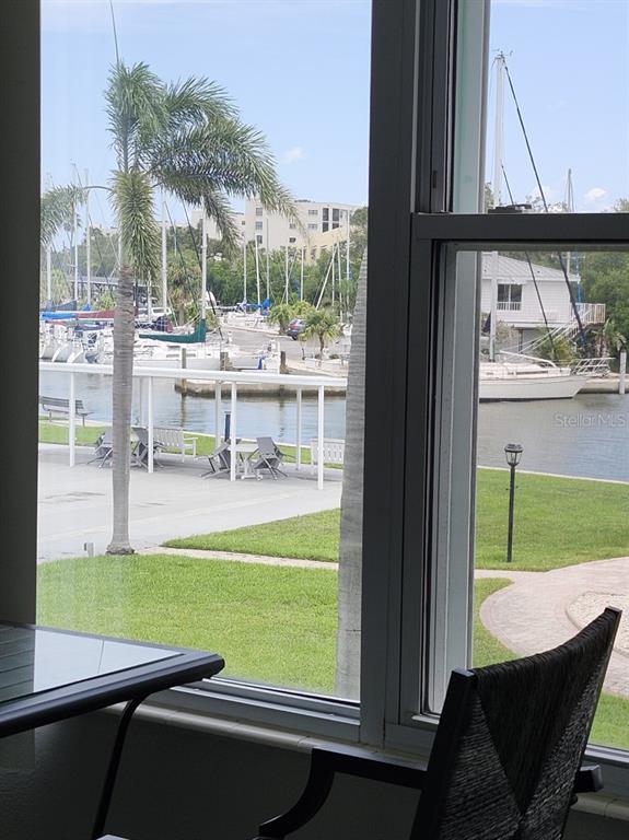 A view of a marina with sailboats and a patio from inside a room — 1819 SHORE DRIVE S UNIT 217, SOUTH PASADENA, FL