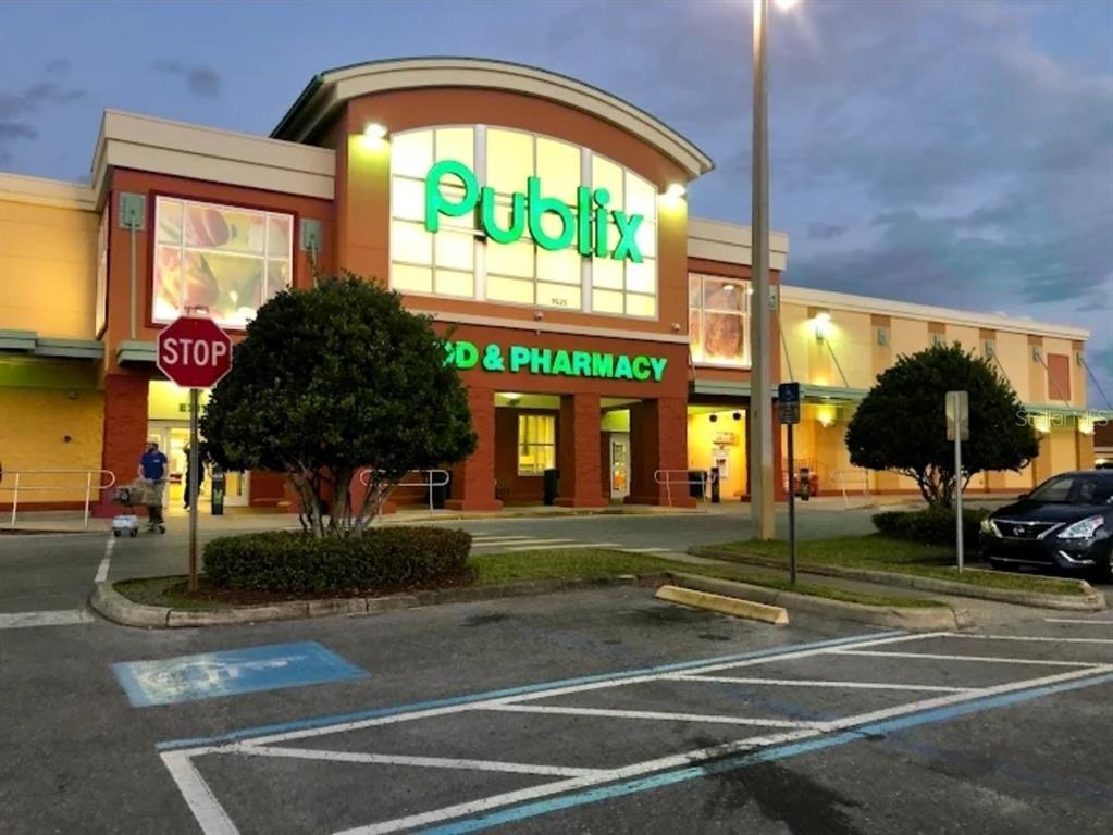 An exterior view of a Publix grocery store with a parking lot in the foreground — 11 SCABIOSA COURT, HOMOSASSA, FL