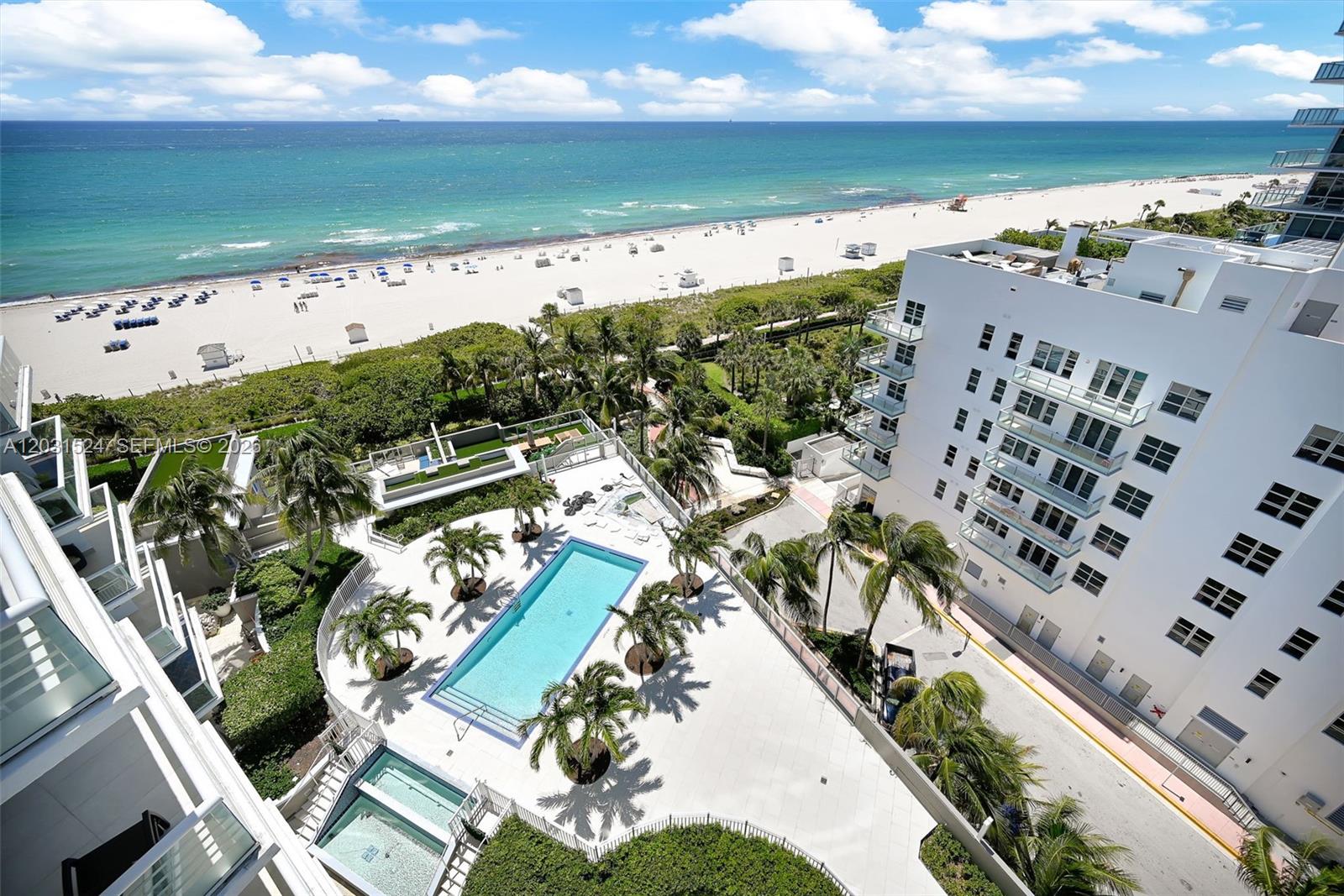 An aerial view shows a swimming pool, a white building, and a beach — 3801 Collins Ave # 1102, Miami Beach FL 33140, MIAMI BEACH, FL