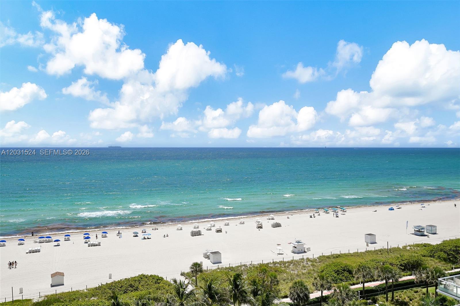 An elevated view of a sandy beach with ocean waves and a clear blue sky — 3801 Collins Ave # 1102, Miami Beach FL 33140, MIAMI BEACH, FL