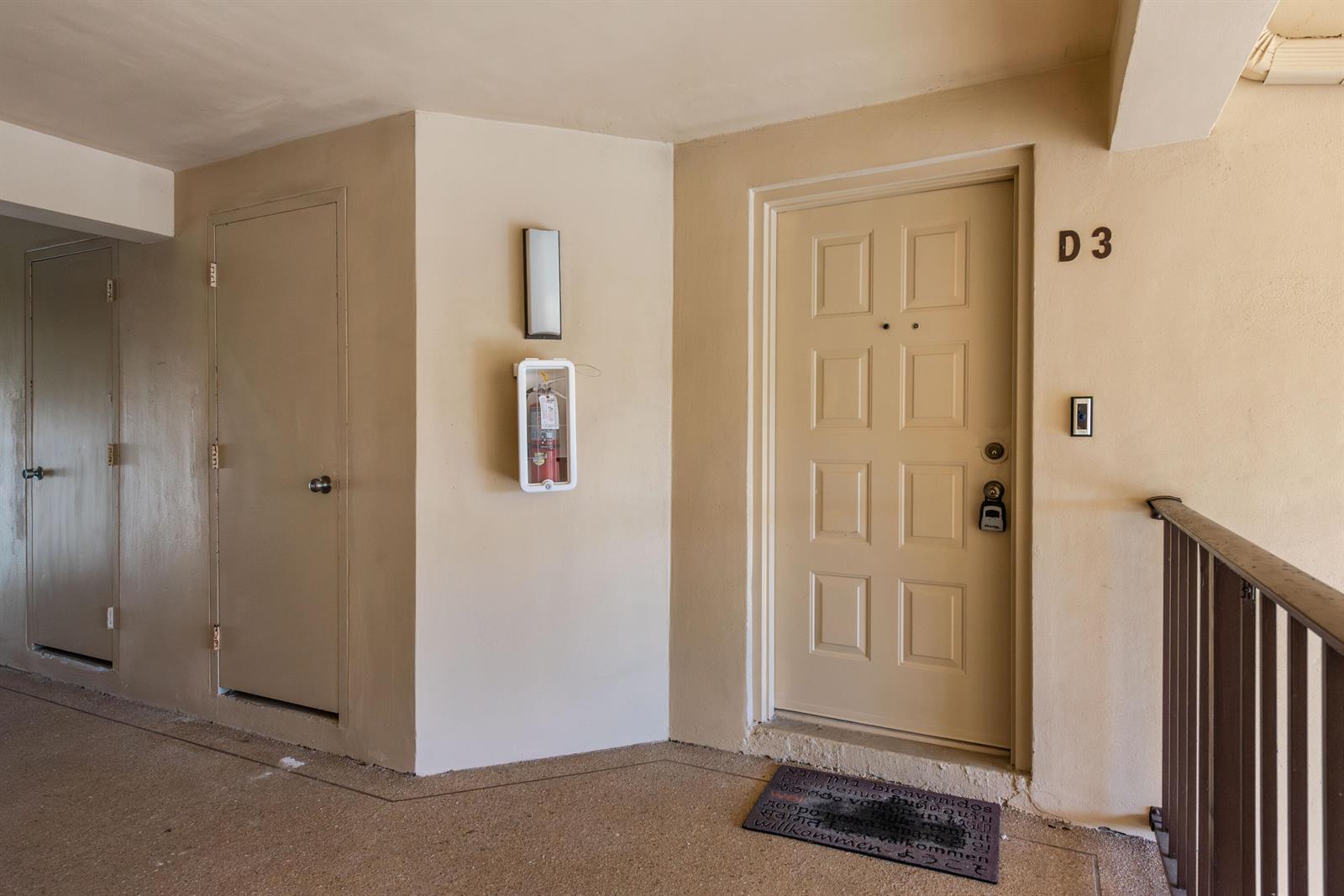 An exterior view of an apartment entrance with a beige door labeled D3 — 629 Sea Pine Way # D3, FL 33415, FL