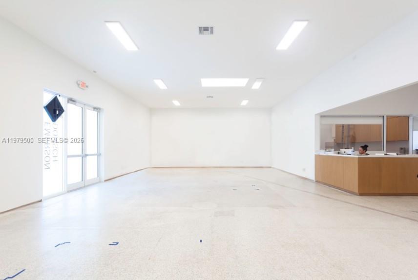 A bright, empty commercial space features white walls, recessed ceiling lights, and a reception desk — 5900 NW 2nd Ave Suite 1, Miami FL 33127, MIAMI, FL