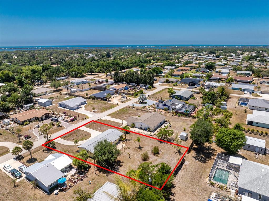 An aerial view shows a single-story house on a large, fenced lot with sparse landscaping — 650 LEACH STREET, ENGLEWOOD, FL
