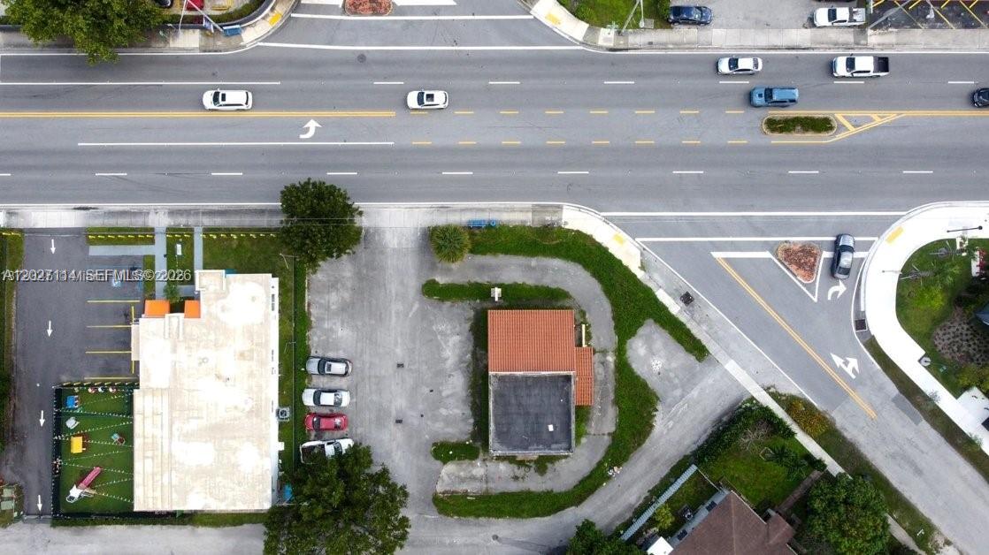 An aerial view shows a small commercial building with a parking lot beside a road — 14100 W Dixie Hwy, North Miami FL 33161, NORTH MIAMI, FL