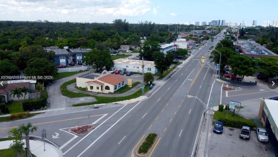 An aerial view shows a commercial building with a red roof near a busy intersection — 14100 W Dixie Hwy, North Miami FL 33161, NORTH MIAMI, FL