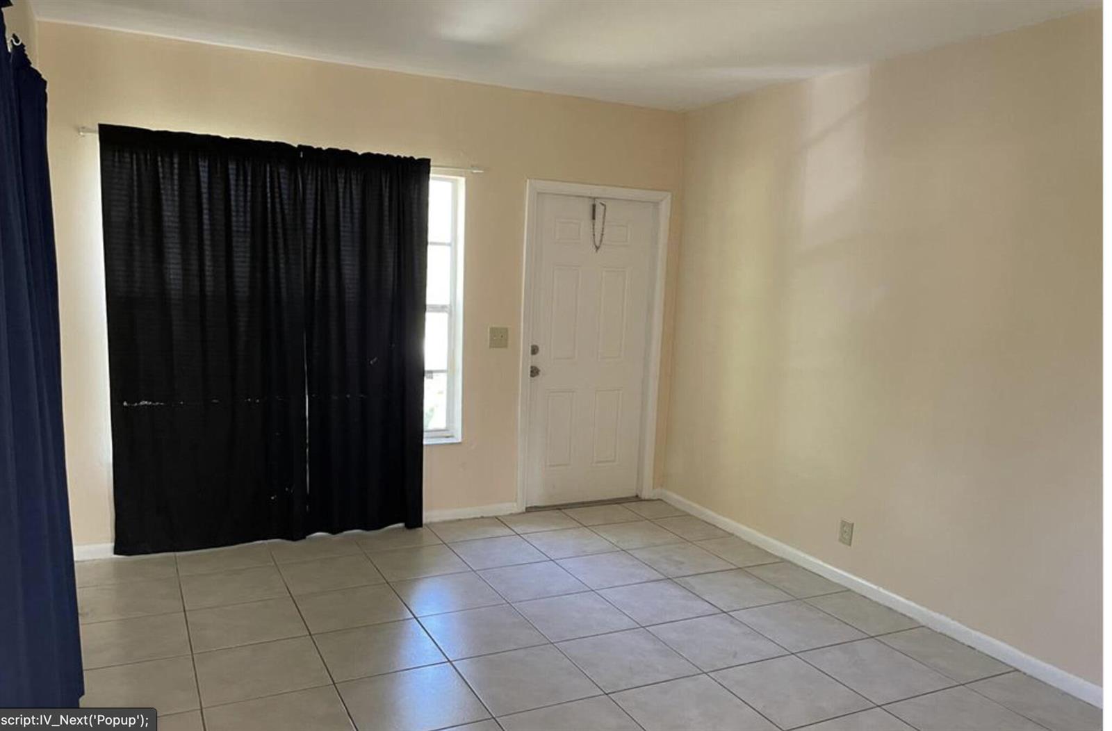 A room with light-colored walls, tiled flooring, a white door, and black curtains — 1328 Lee Street, Delray Beach FL 33444, DELRAY BEACH, FL