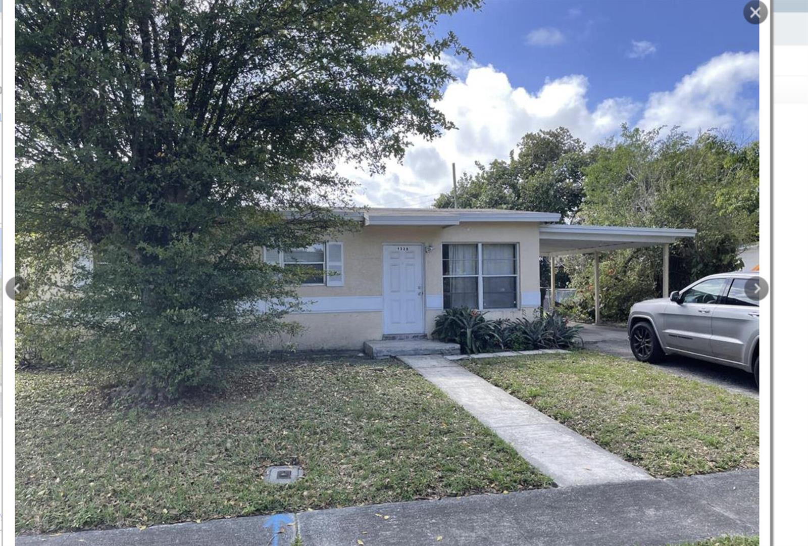 A single-story house with a beige exterior, a front walkway, and an attached carport — 1328 Lee Street, Delray Beach FL 33444, DELRAY BEACH, FL