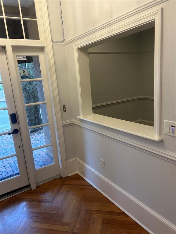 An interior view shows a doorway with a glass-paned door and a rectangular wall cutout — 5214 SW 91ST TERRACE, GAINESVILLE, FL