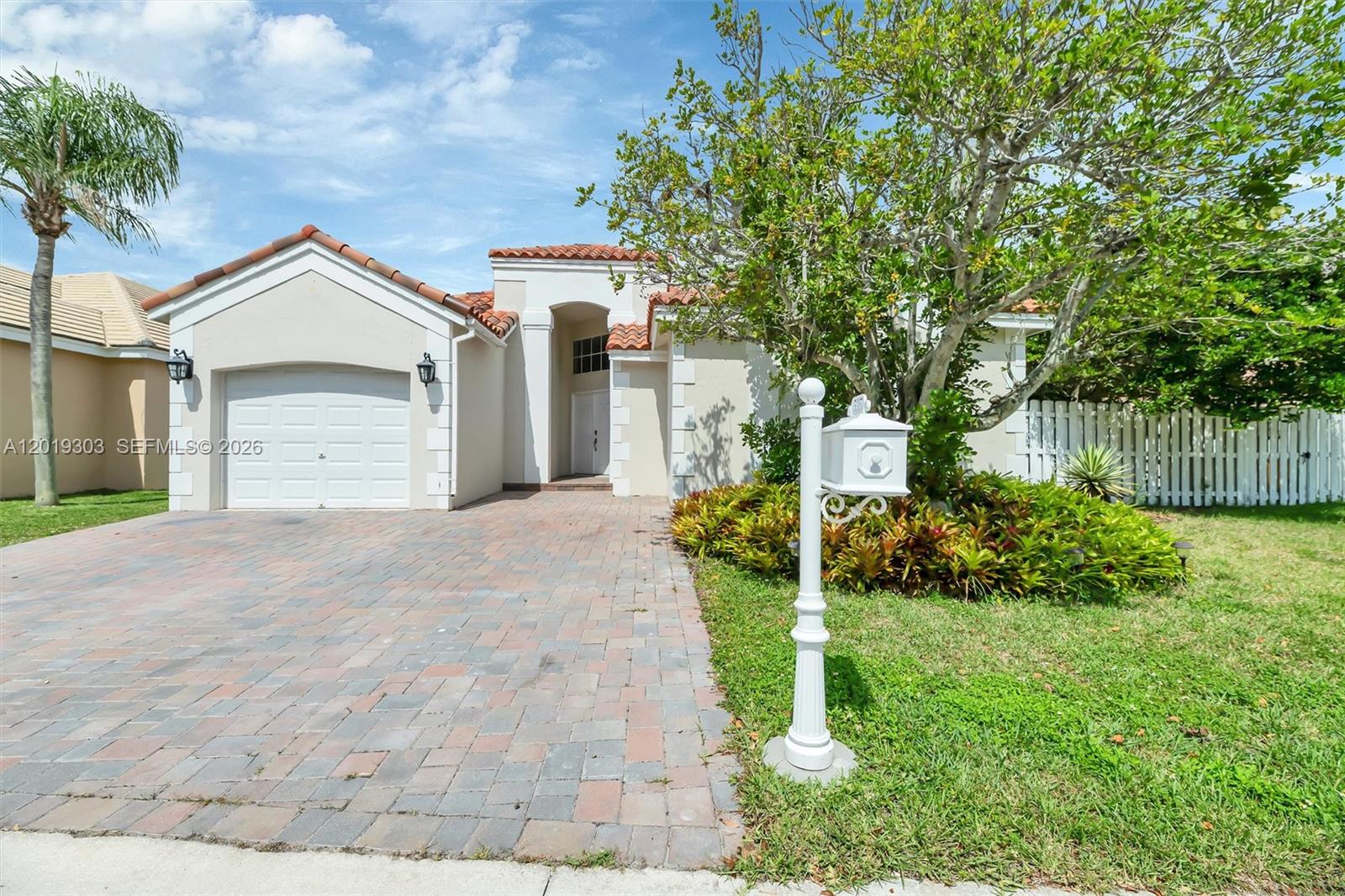 A single-story house with a paved driveway, a garage, and a white mailbox in front — 535 Somerset Way, Weston FL 33326, WESTON, FL