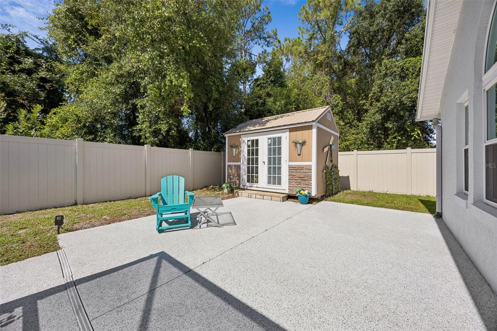 A single-story house with a concrete driveway, a two-car garage, and a large front lawn — 1 BRUNSWICK LANE, PALM COAST, FL
