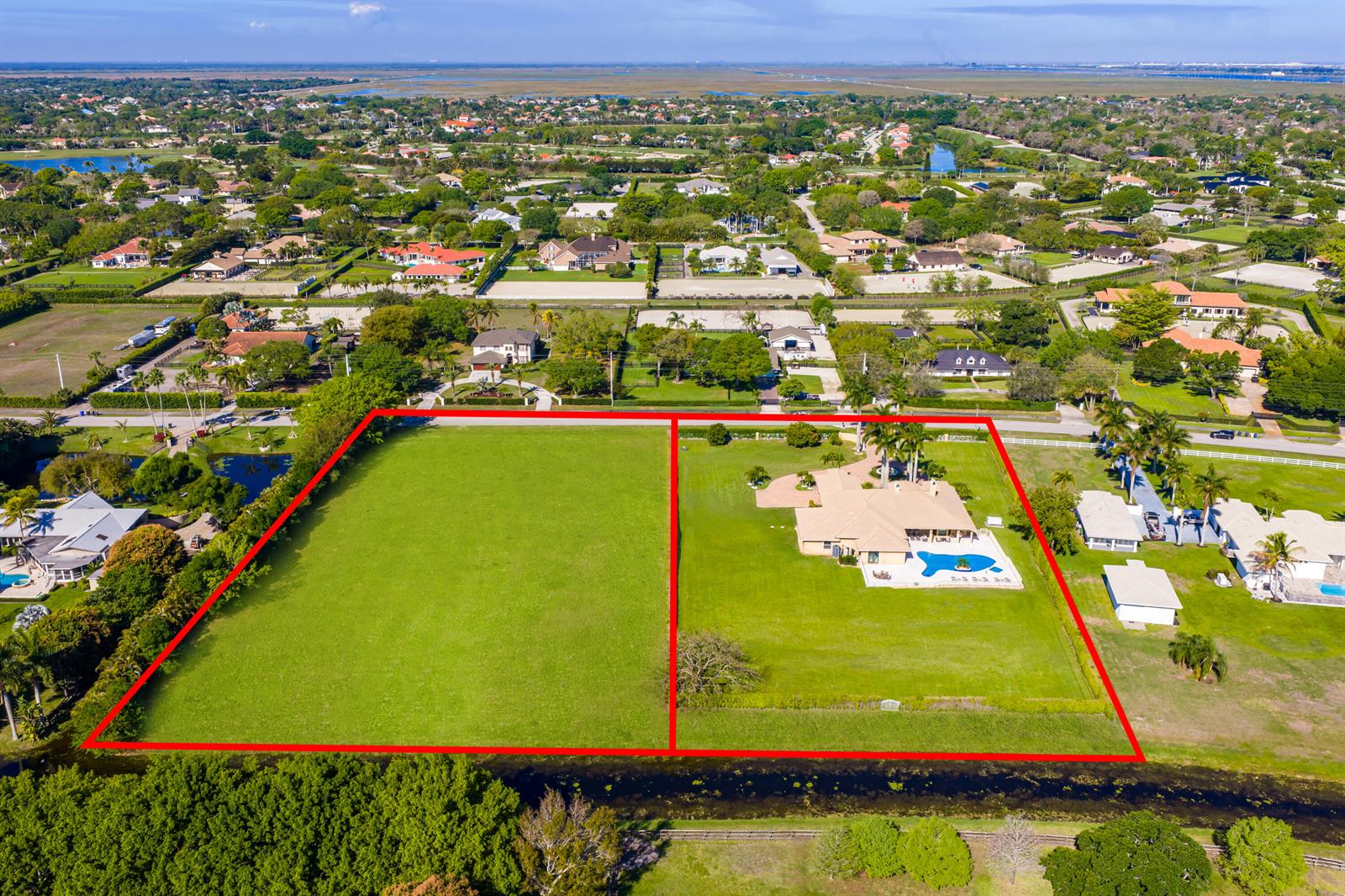 An aerial view shows two adjacent residential lots, one vacant and one with a house — 14404 Wellington Trace, Wellington FL 33414, WELLINGTON, FL