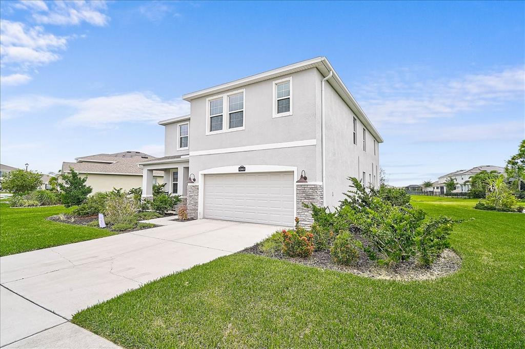 A two-story house with a light gray stucco exterior and a two-car garage — 12664 NIGHT VIEW DRIVE, SARASOTA, FL
