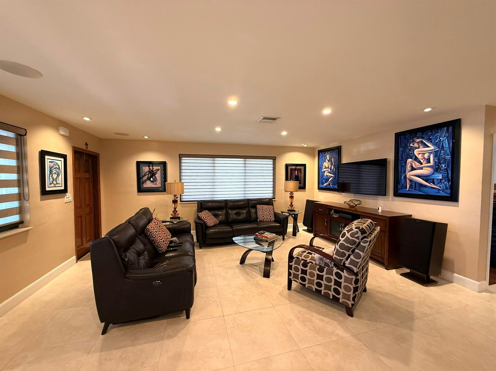 A living room features leather sofas, a patterned armchair, tile flooring, and several framed paintings — 5170 Palm Avenue, Hialeah FL 33012, HIALEAH, FL