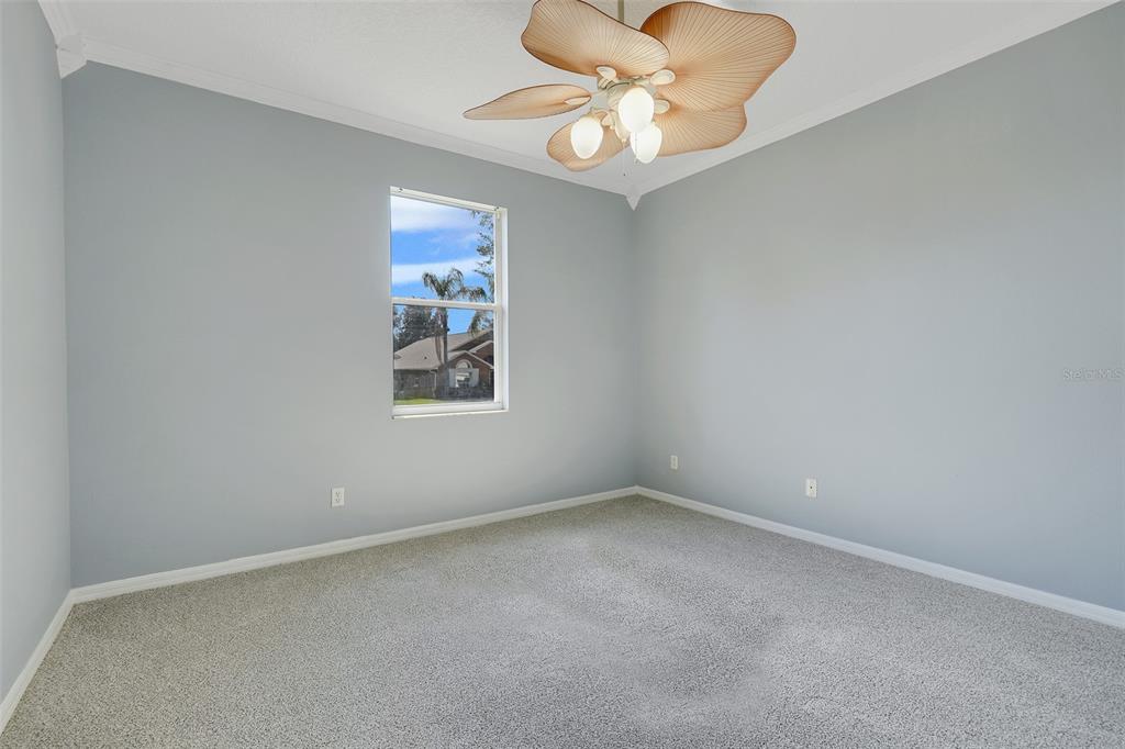 An entryway features light blue walls, a tiled floor, a white front door, and a doorway — 1141 GREENLEY AVENUE, GROVELAND, FL