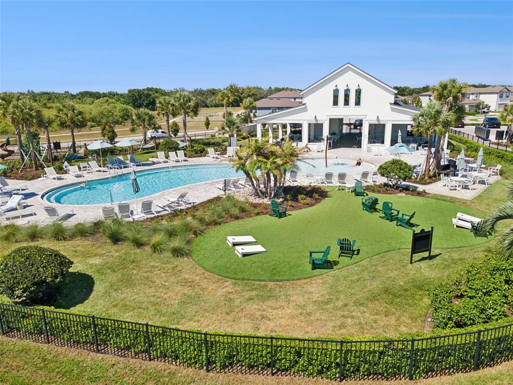 An aerial view shows a community swimming pool, a clubhouse, and a grassy lawn area — 1218 LAKERIDGE WAY, LAKE ALFRED, FL
