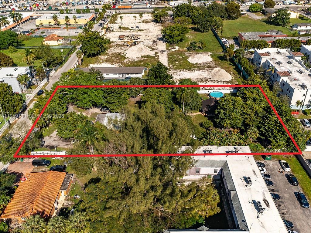 An aerial view shows a rectangular lot with trees, a house, and a swimming pool — 13265 Alexandria Dr, Opa-Locka FL 33054, OPA-LOCKA, FL