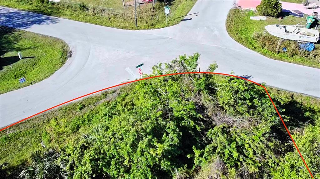 An aerial view of a corner lot outlined in red at a road intersection — 11272 7TH AVENUE, PUNTA GORDA, FL