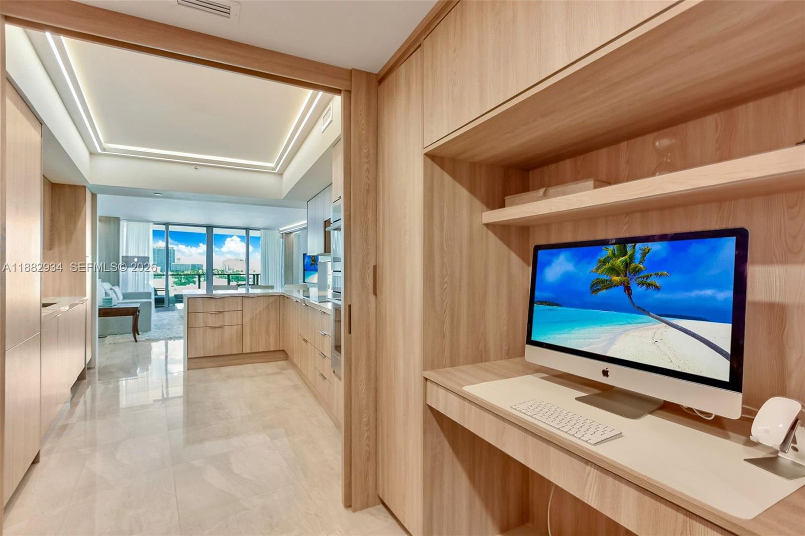 A modern bathroom features a floating wood vanity, a textured accent wall, and a soaking tub — 1455 Ocean Dr # 811, Miami Beach FL 33139, MIAMI BEACH, FL