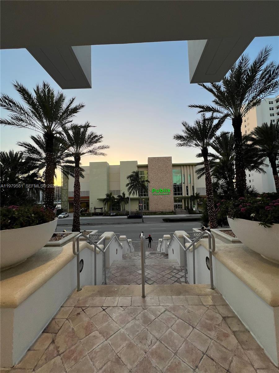 A view from a stone staircase looking toward a Publix grocery store across a street — 3101 S Ocean Dr # 3102, Hollywood FL 33019, HOLLYWOOD, FL