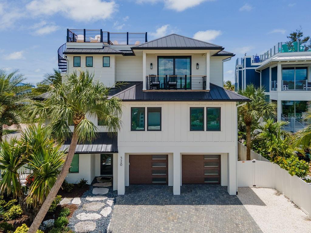A three-story coastal home with a rooftop deck, balcony, and two-car garage — 526 SEAGULL WAY, ANNA MARIA, FL