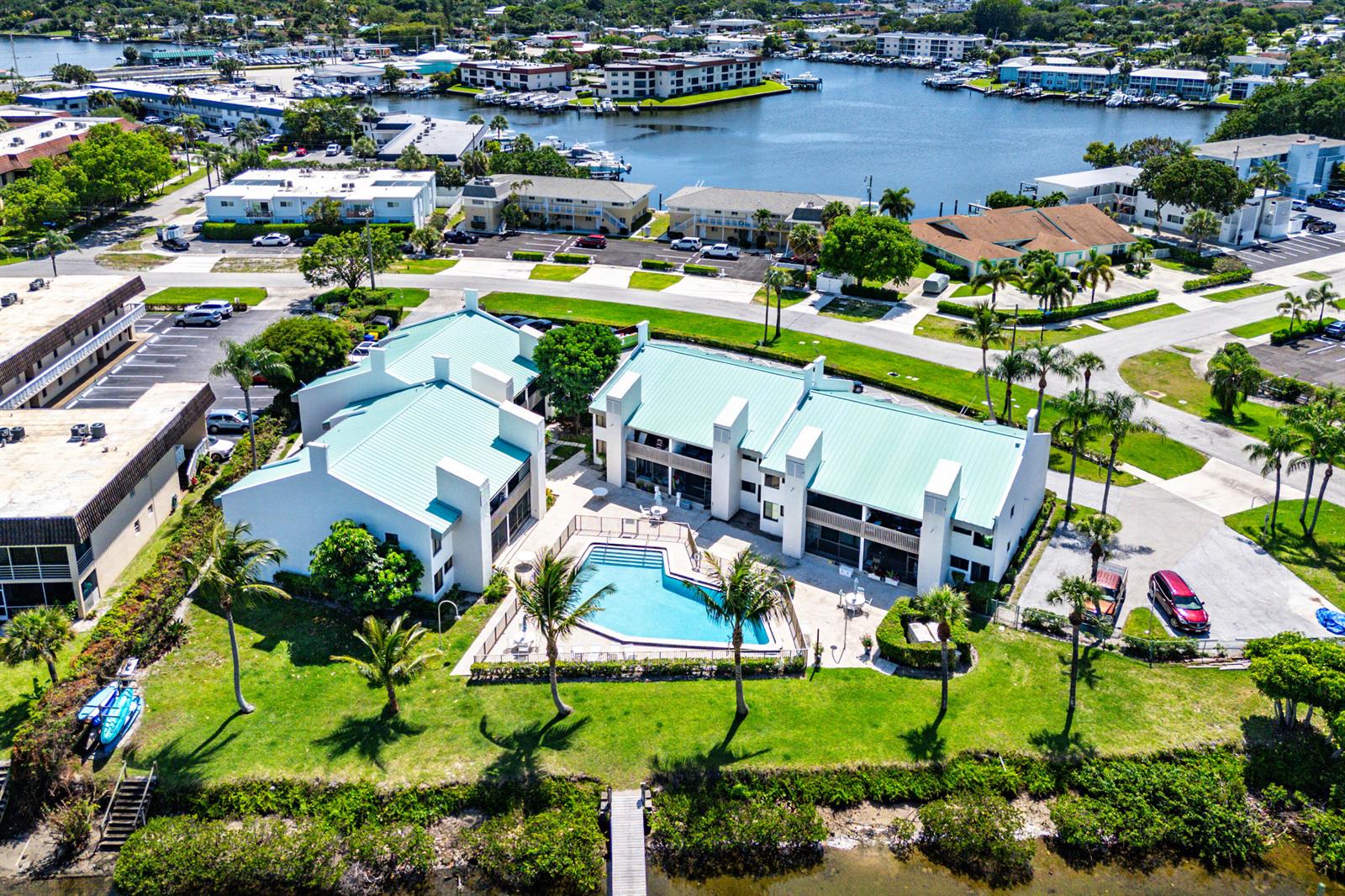 An aerial view shows a multi-unit residential complex with a central swimming pool and dock — 412 Southwind Drive # B2, North Palm Beach FL 33408, NORTH PALM BEACH, FL