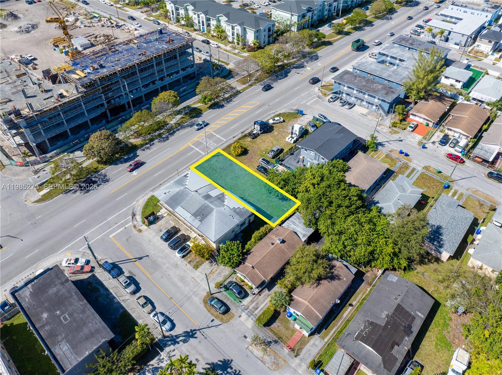 An aerial view shows a rectangular lot highlighted in yellow next to a commercial building — 6425 NW 12th Ave, Miami FL 33150, MIAMI, FL