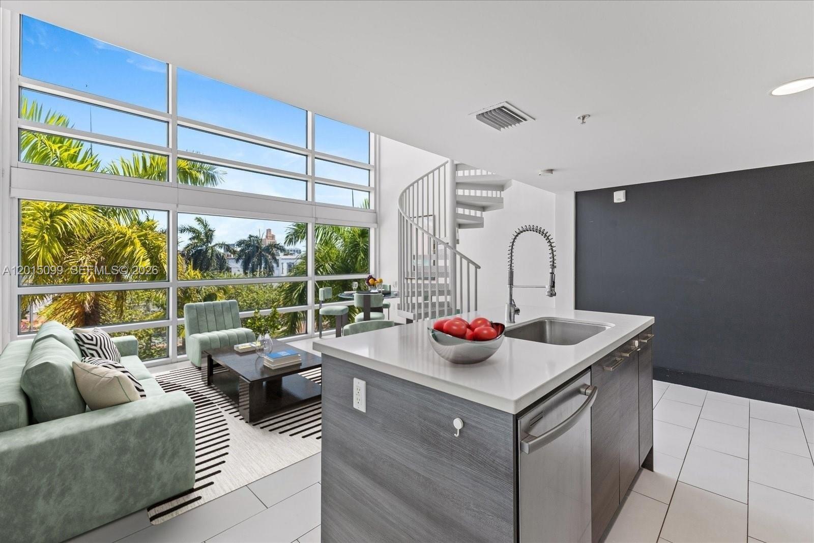 A modern living room and kitchen area features floor-to-ceiling windows and a spiral staircase — 421 Meridian Ave # 19, Miami Beach FL 33139, MIAMI BEACH, FL
