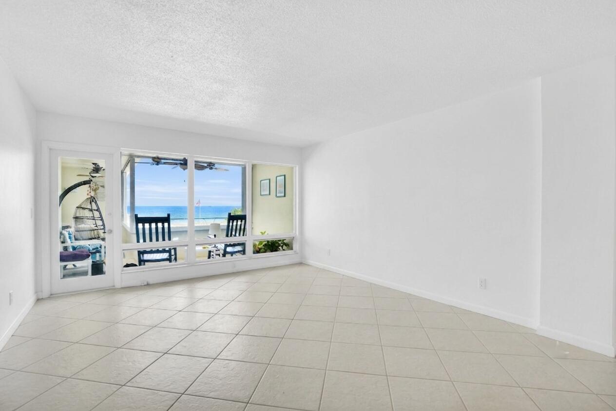 An empty room with white walls, tile flooring, and a large window overlooking the ocean — 1850 S Ocean Boulevard # 304, Pompano Beach FL 33062, POMPANO BEACH, FL