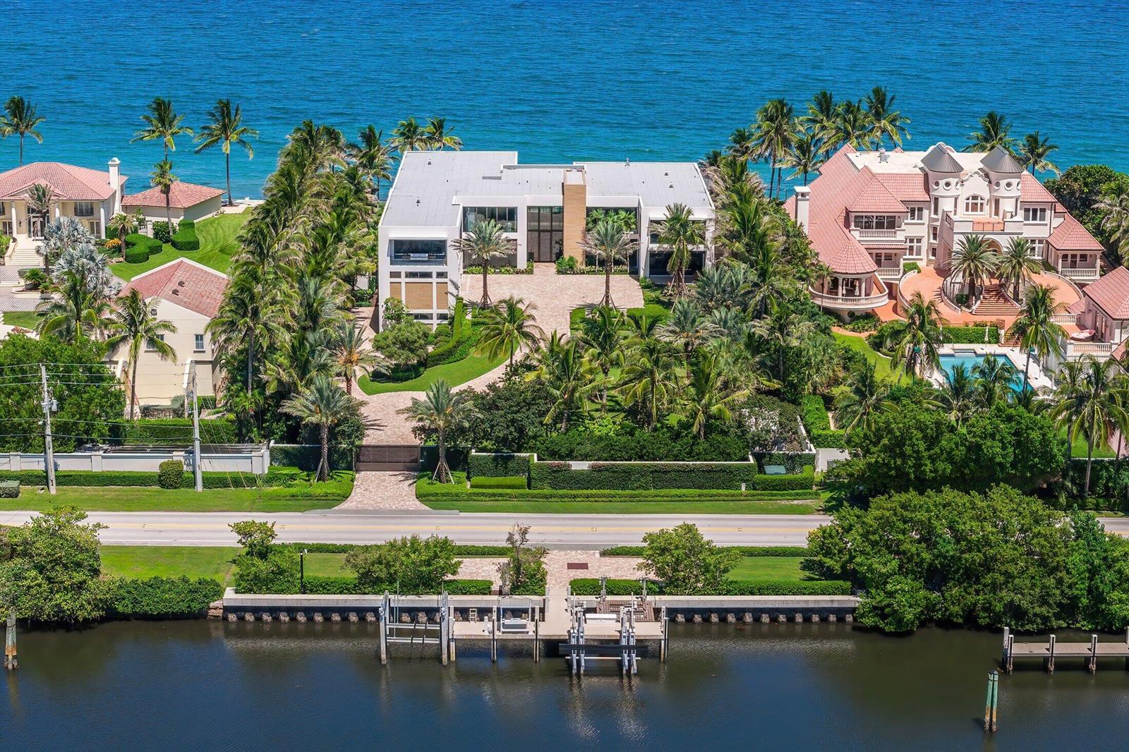 An aerial view shows a modern white house between two traditional homes along the coast — 1260 S Ocean Boulevard, Manalapan FL 33462, MANALAPAN, FL
