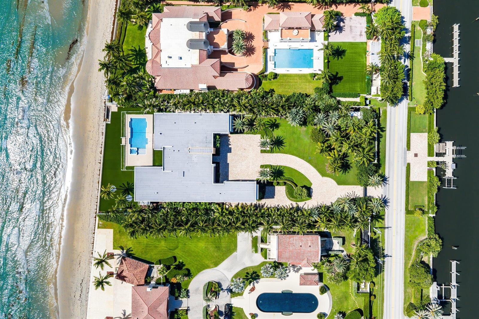An aerial view shows luxury waterfront homes with pools, palm trees, and private boat docks — 1260 S Ocean Boulevard, Manalapan FL 33462, MANALAPAN, FL