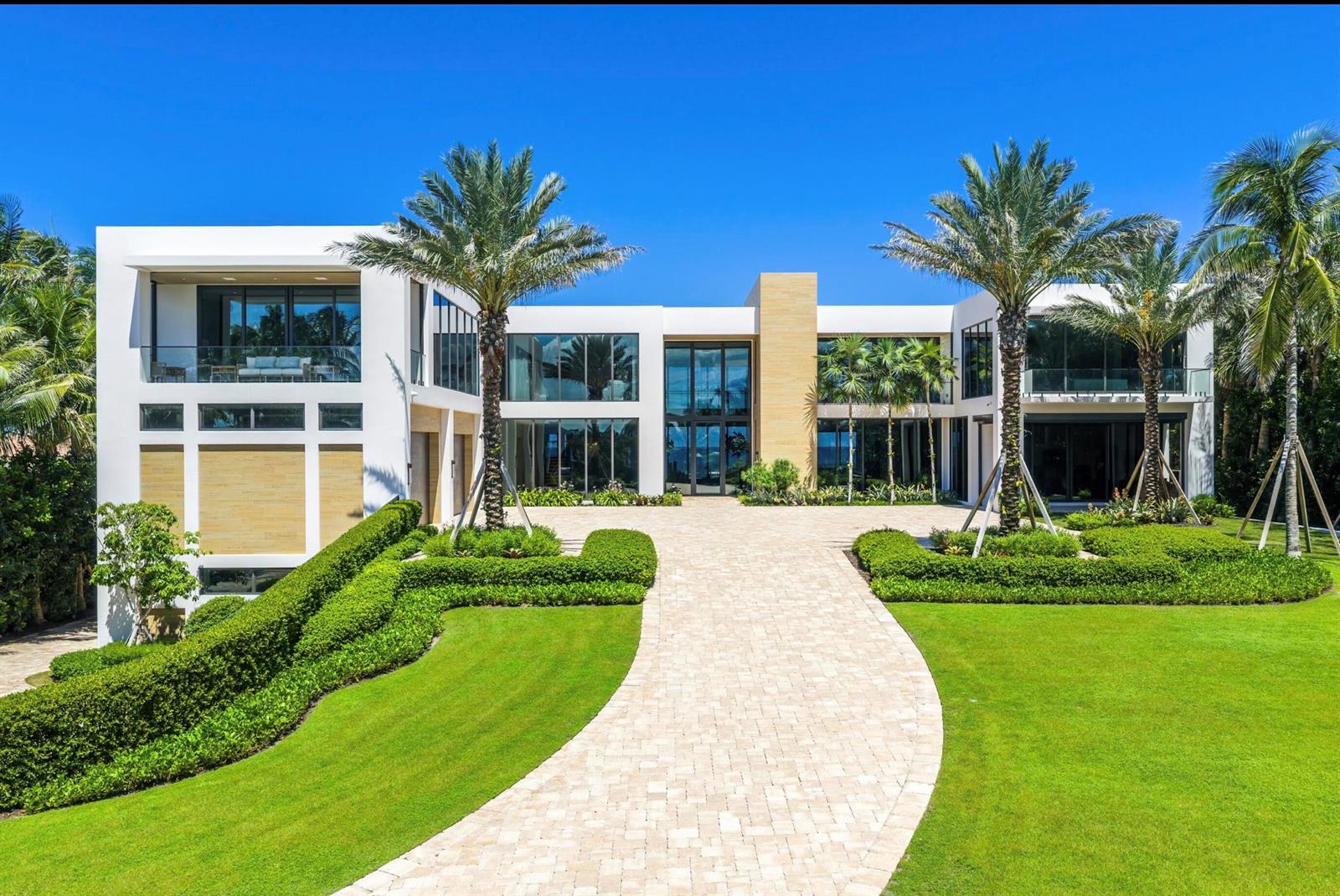 A modern two-story white mansion with a paved driveway, manicured hedges, and palm trees — 1260 S Ocean Boulevard, Manalapan FL 33462, MANALAPAN, FL