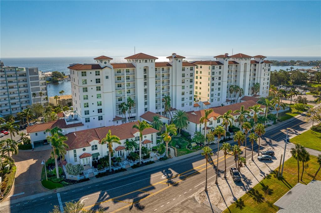 An aerial view of a multi-story residential building with a red tile roof near water — 1325 SNELL ISLE BOULEVARD NE UNIT 711, ST PETERSBURG, FL