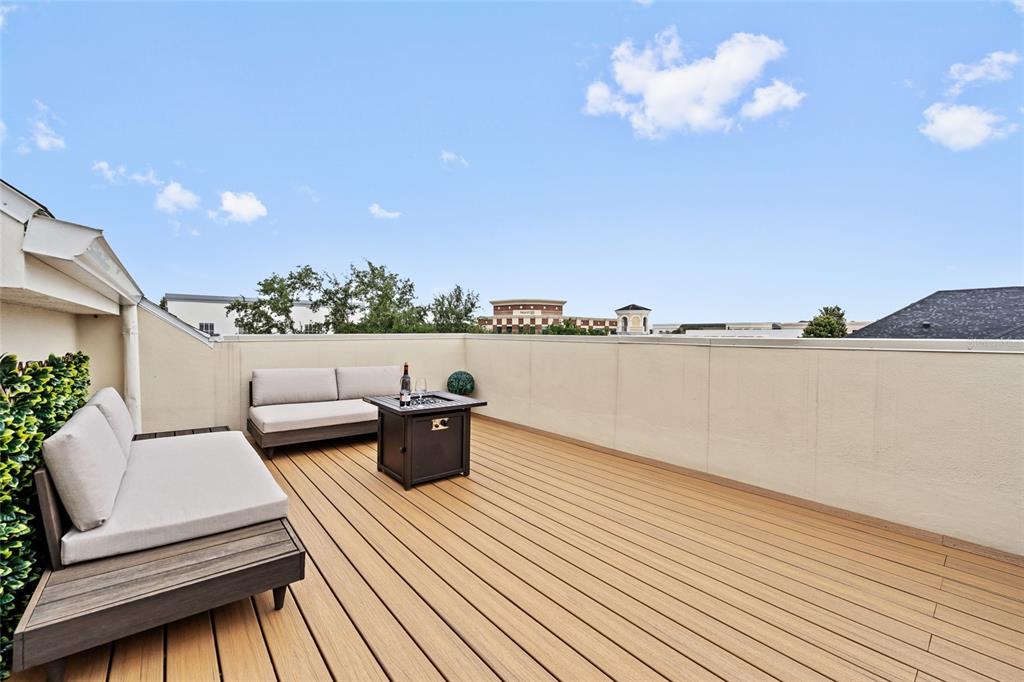 A rooftop deck features light-colored outdoor sofas, a fire pit, and wood-look composite decking — 1451 COMMON WAY ROAD, ORLANDO, FL