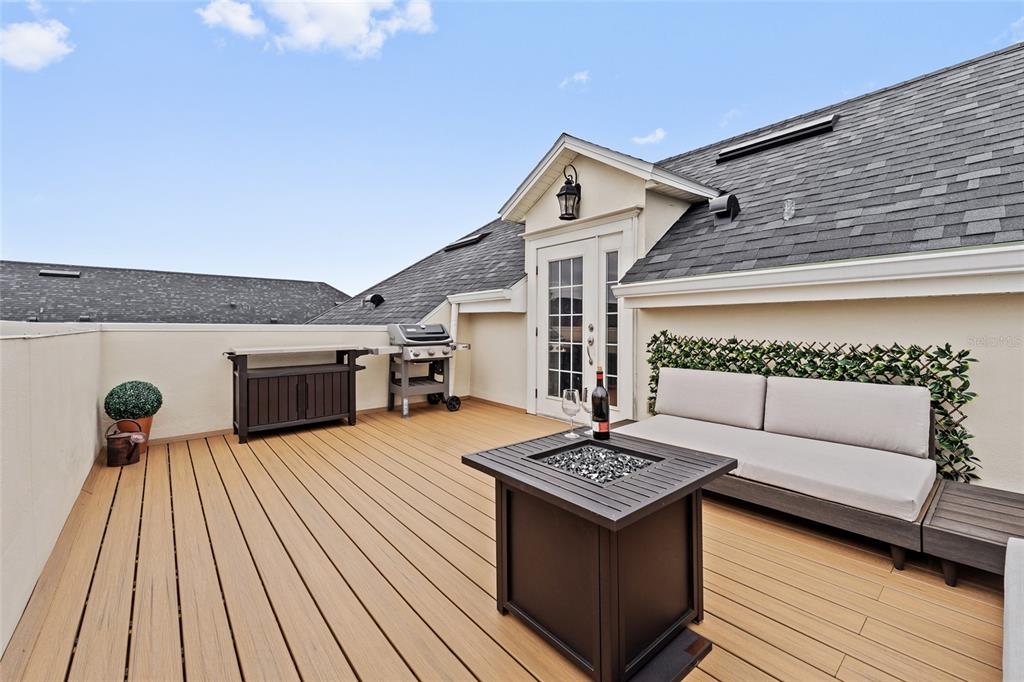 A rooftop deck features a fire pit, outdoor sofa, grill, and light-colored composite decking — 1451 COMMON WAY ROAD, ORLANDO, FL