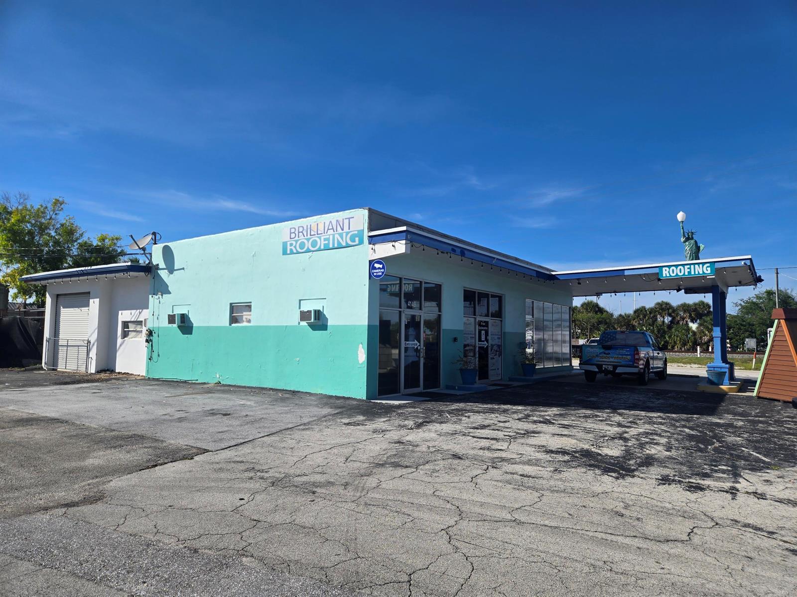 A teal commercial building with a covered drive-through area and a small Statue of Liberty — 4149 SE Salerno Road # A, Stuart FL 34997, STUART, FL