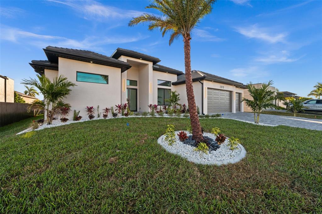 A modern single-story house with a palm tree in the front yard — 109 SW 37TH PLACE, CAPE CORAL, FL