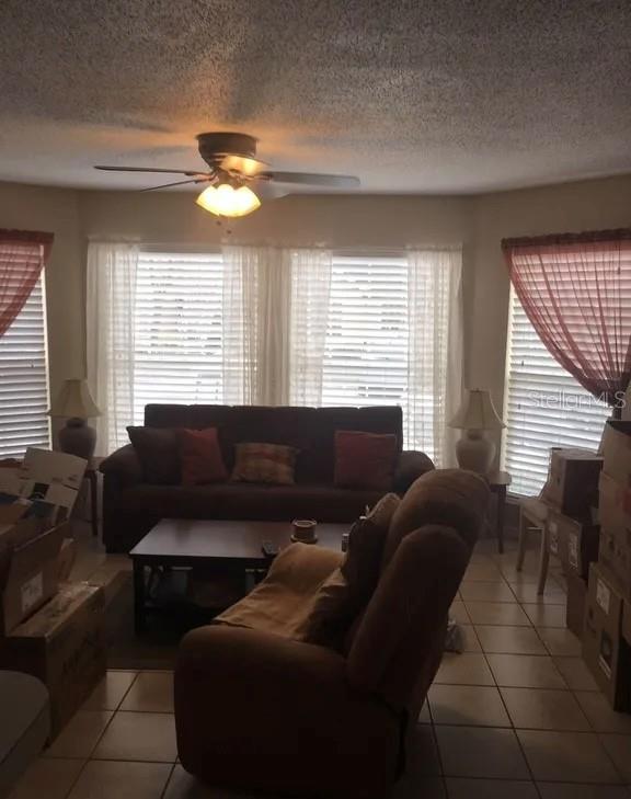 A living room features a brown sofa, a recliner, a coffee table, and large windows — 634 STEAMBOAT COURT UNIT 167, ALTAMONTE SPRINGS, FL