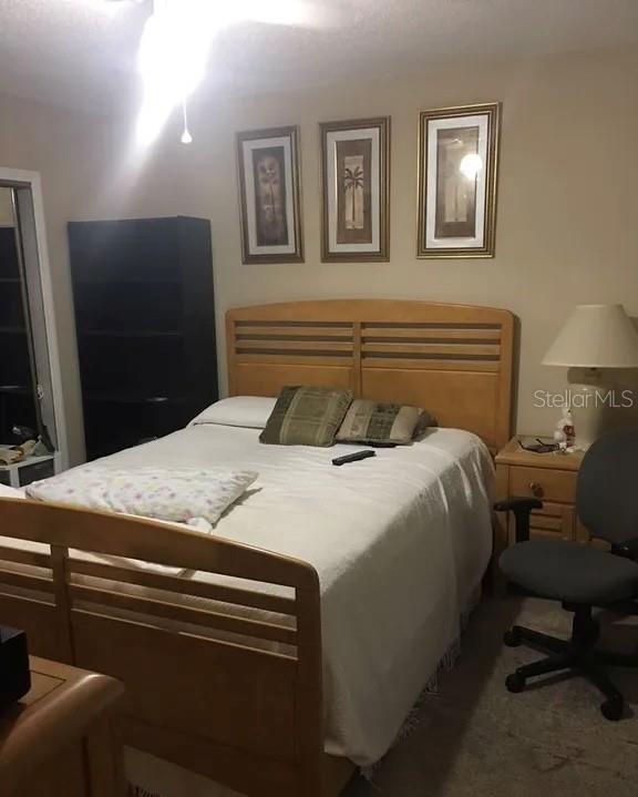 A bedroom features a light wood bed frame, three framed wall pictures, and a desk chair — 634 STEAMBOAT COURT UNIT 167, ALTAMONTE SPRINGS, FL